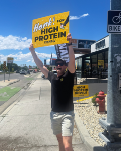 Konala franchisee waving a honk for high protein sign